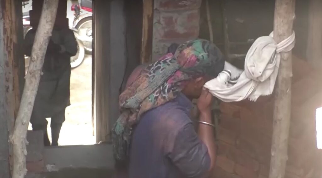 construction worker wiping face with cloth