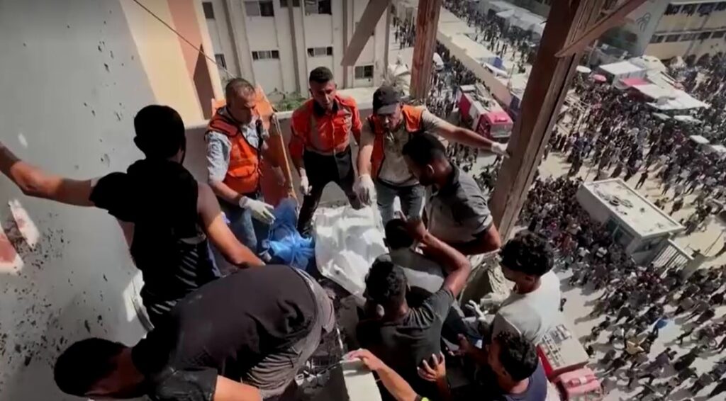 rescuers cover body in Israeli attacks hospital in Gaza