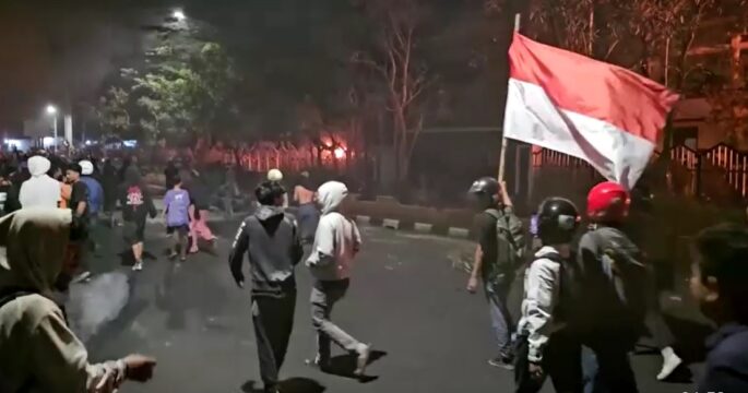 Indonesian protesters holding flag